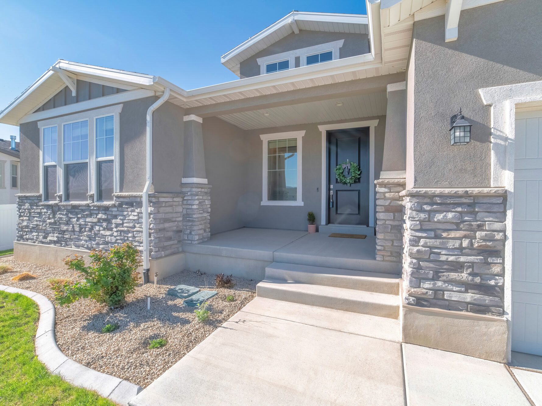 Front exterior of a house with nice front yard and garage